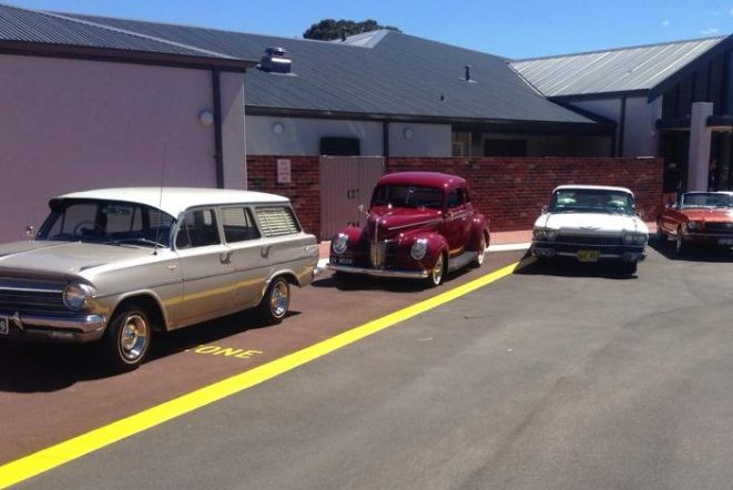 Classic cars parked outside club venue