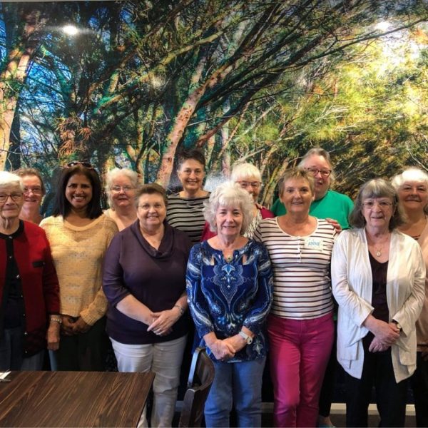 Group of club members standing together indoors