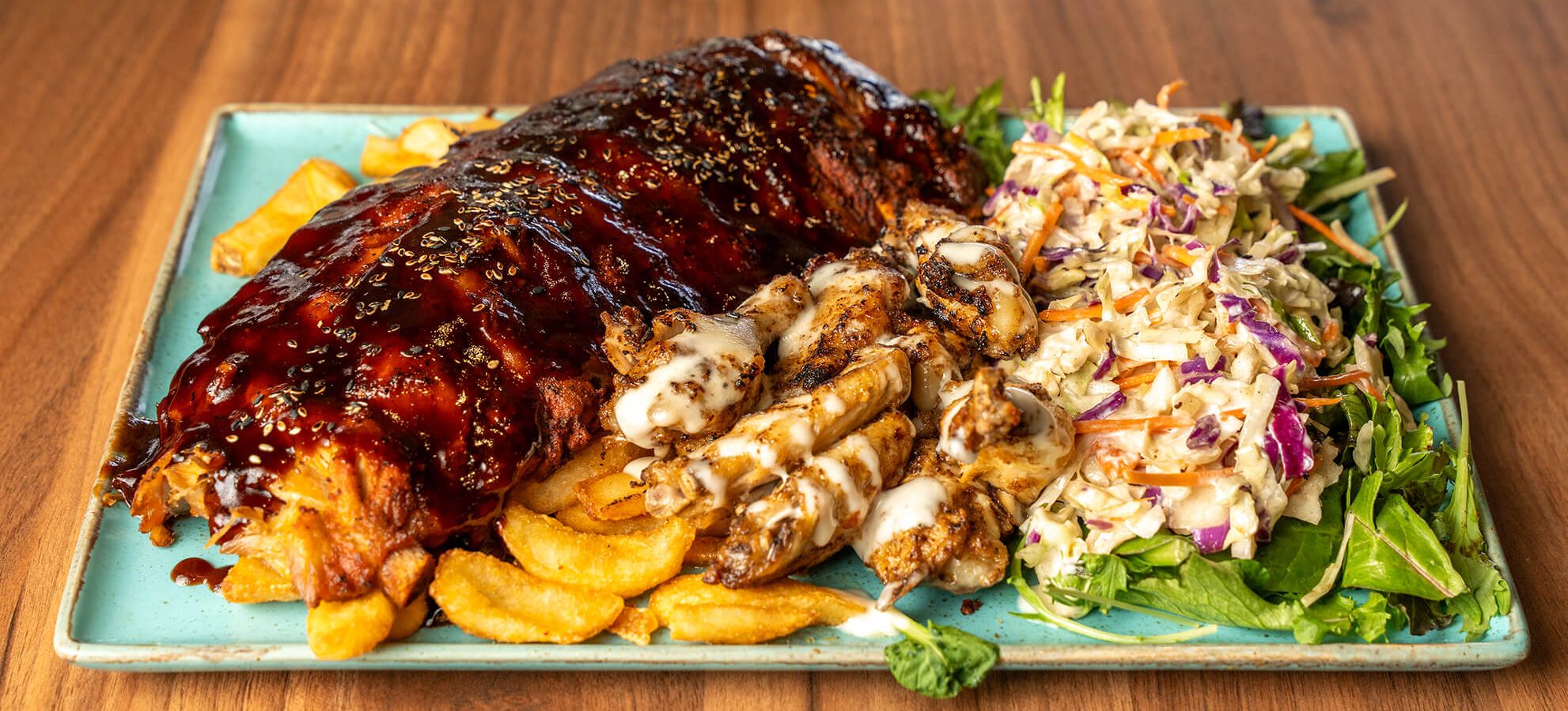 Bourbon pork ribs with chicken wings on a plate